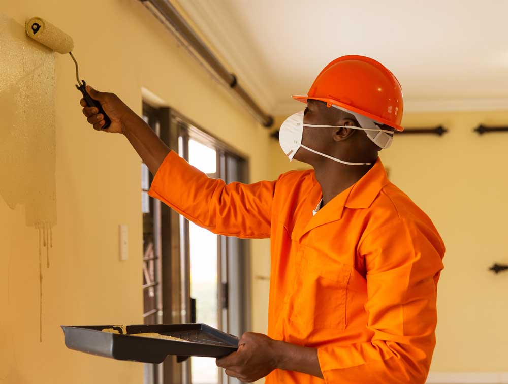 Construction Worker painting a wall | US Dept. of the Interior | A James Global