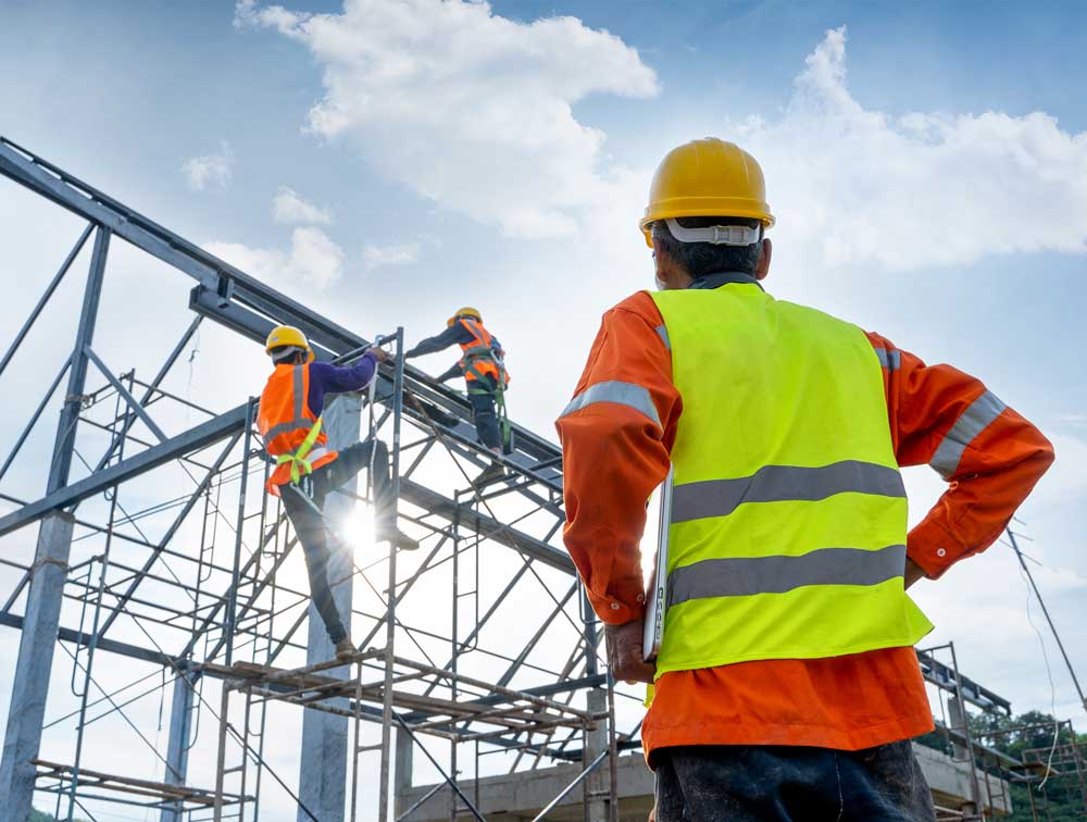 Engineer Technician observes team of workers on steel platform | J & J Global Enterprises | A James Global